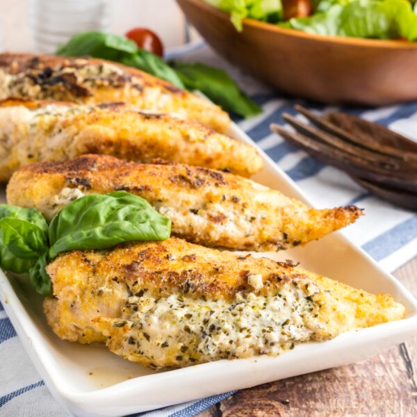 square picture of stuffed chicken breasts on a platter