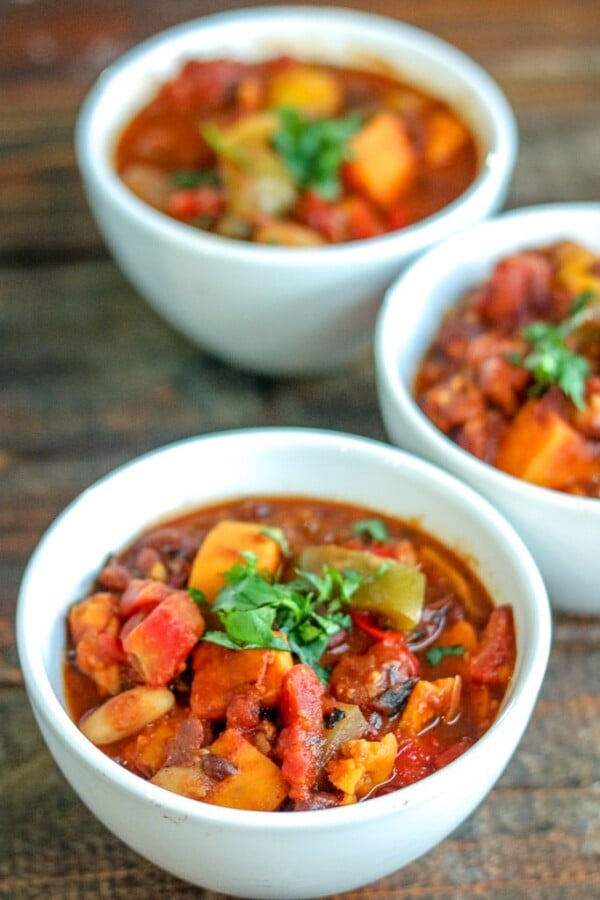 vegetarian chili in white bowls on a wooden background
