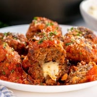 cheese stuffed meatballs on a white plate
