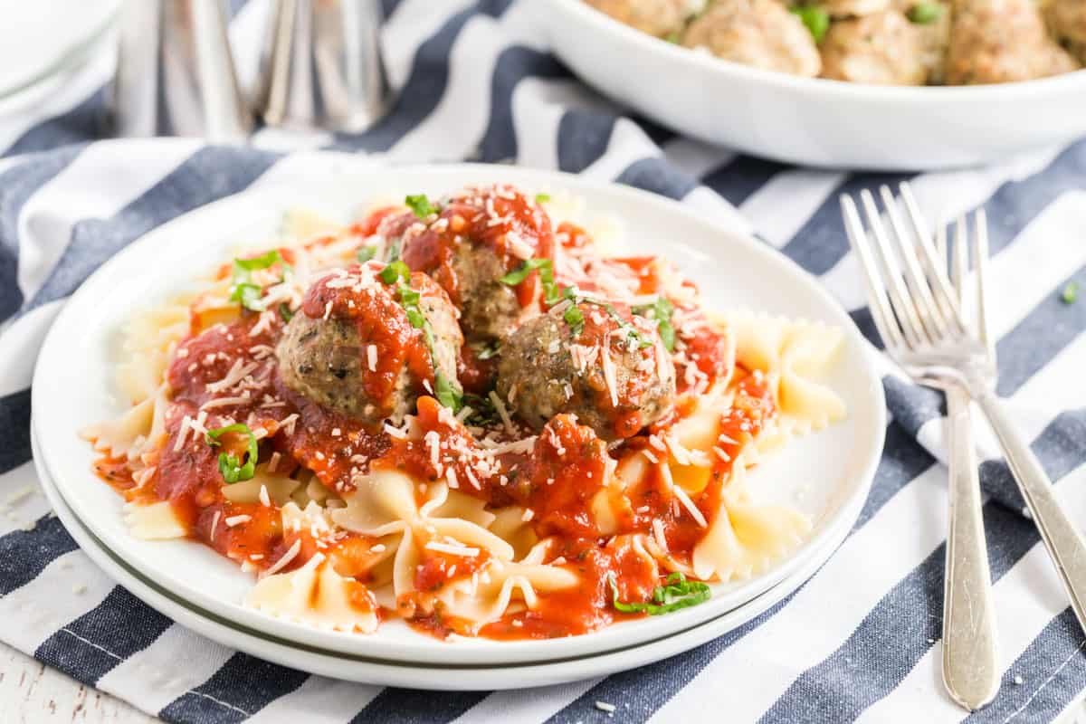 A plate of turkey meatballs with marinara over pasta