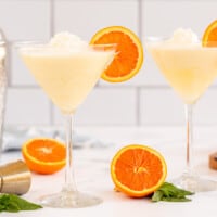 2 orange cream martinis with a cocktail shaker