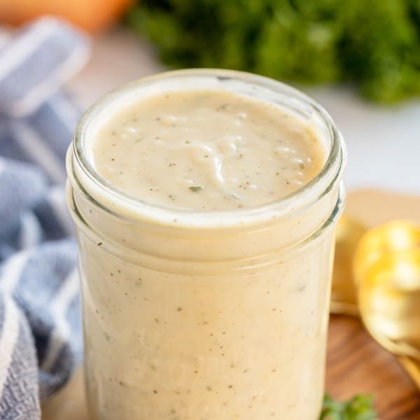 homemade cream of chicken soup in a jar on a wooden board