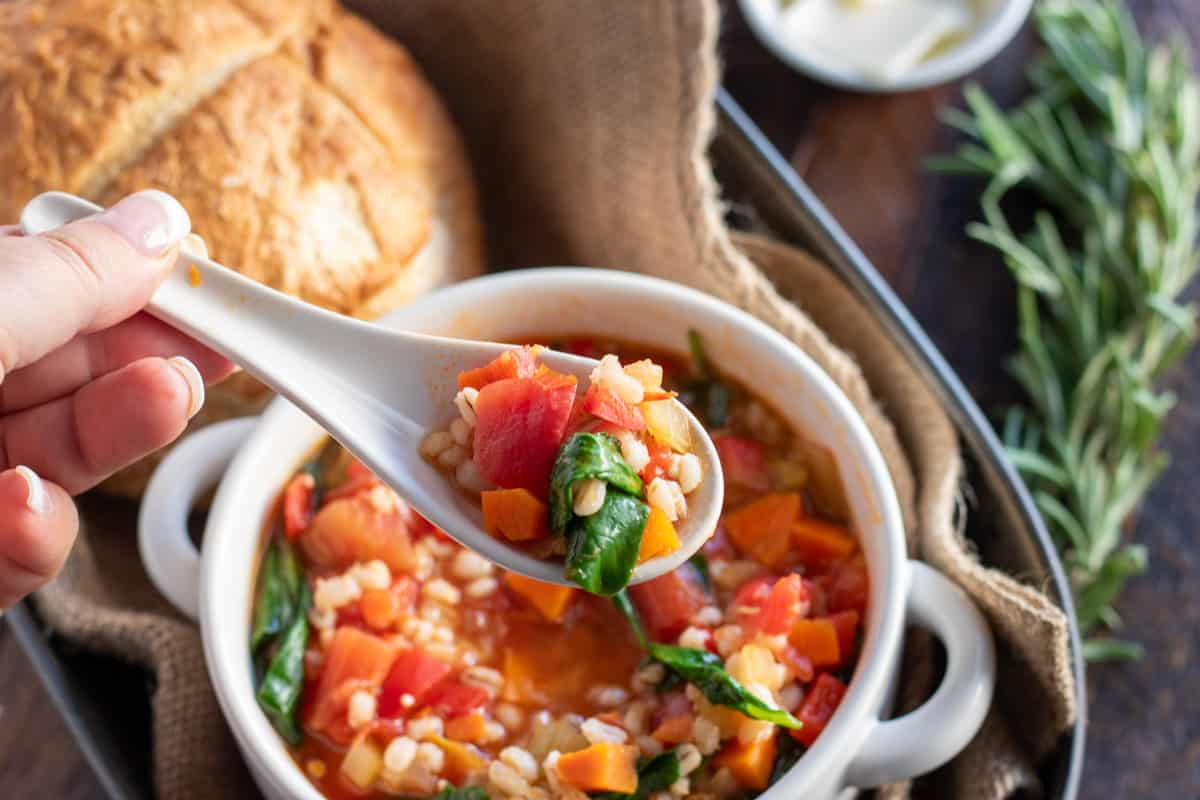 vegetable barley soup on a spoon