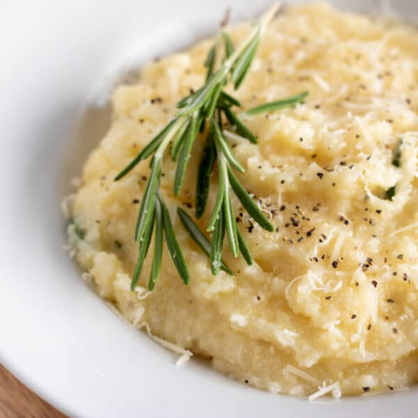 bowl of parmesan polenta with rosemary.