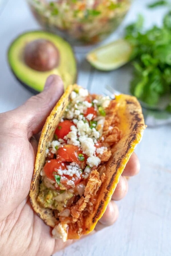a chicken taco in a hand