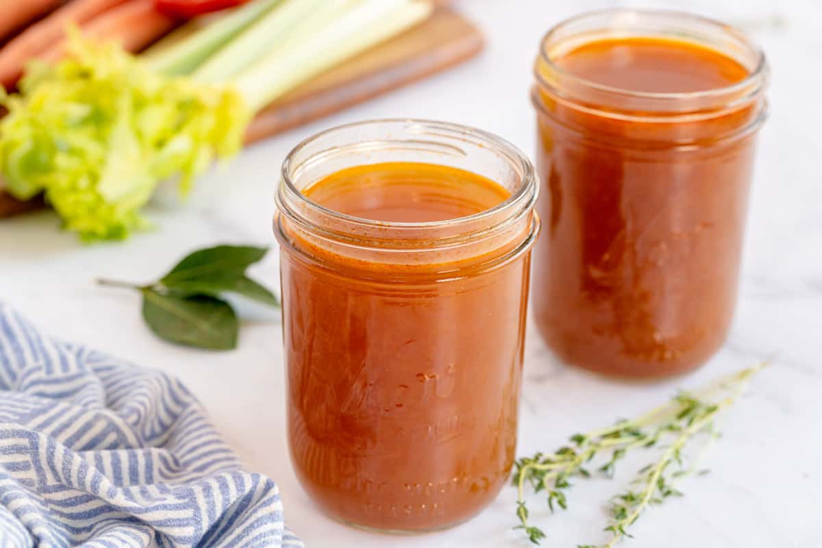 vegetable stock in a jar with celery