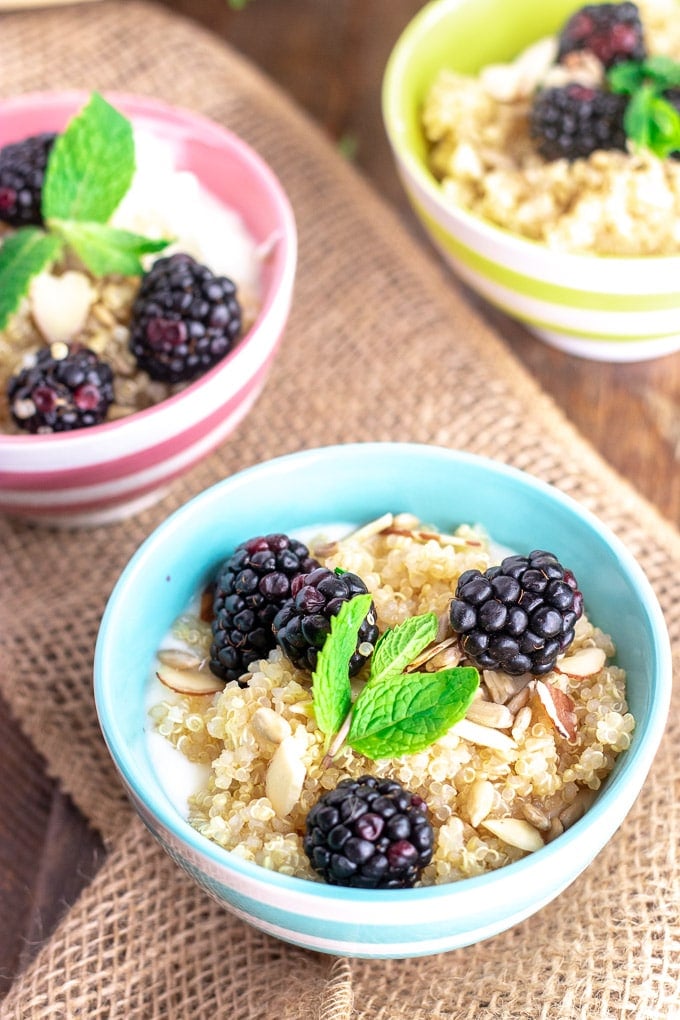 quinoa breakfast bowls with blackberries in colorful bowls 