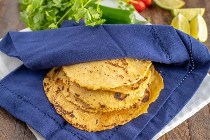 corn tortillas in a blue cloth napkin