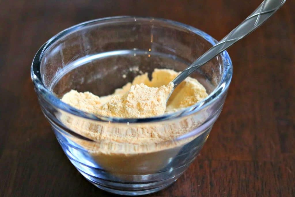 browned flour in a glass bowl with a spoon