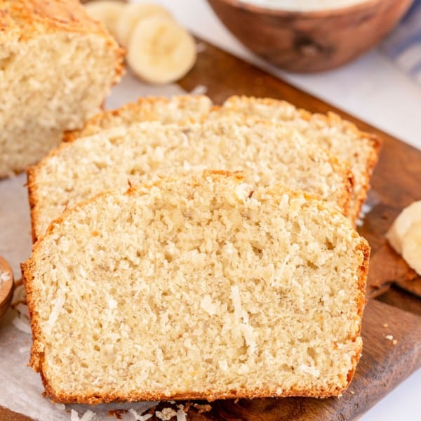 two slices of coconut banana bread with coconut and sliced bananas