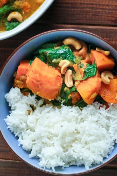 sweet potato curry with rice in a blue bowl.
