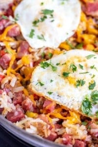 corned beef hash in a skillet with fried eggs