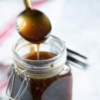 Homemade Teriyaki Sauce in a glass jar with a spoon
