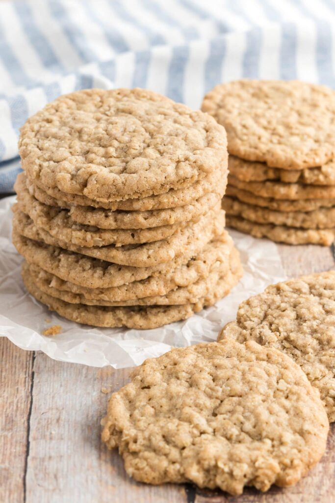 oatmeal cookies stacked on a plate with a striped napkin