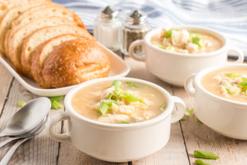 asian chicken soup with a loaf of bread