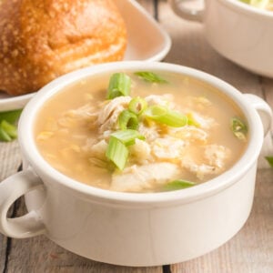 square pic of asian chicken soup in a white bowl.