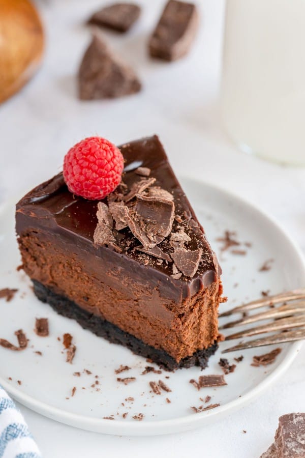 slice of chocolate cheesecake with a raspberry on top