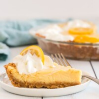 lemon pie on a white plate with a fork