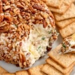 ham and pineapple cheese ball on a plate with crackers