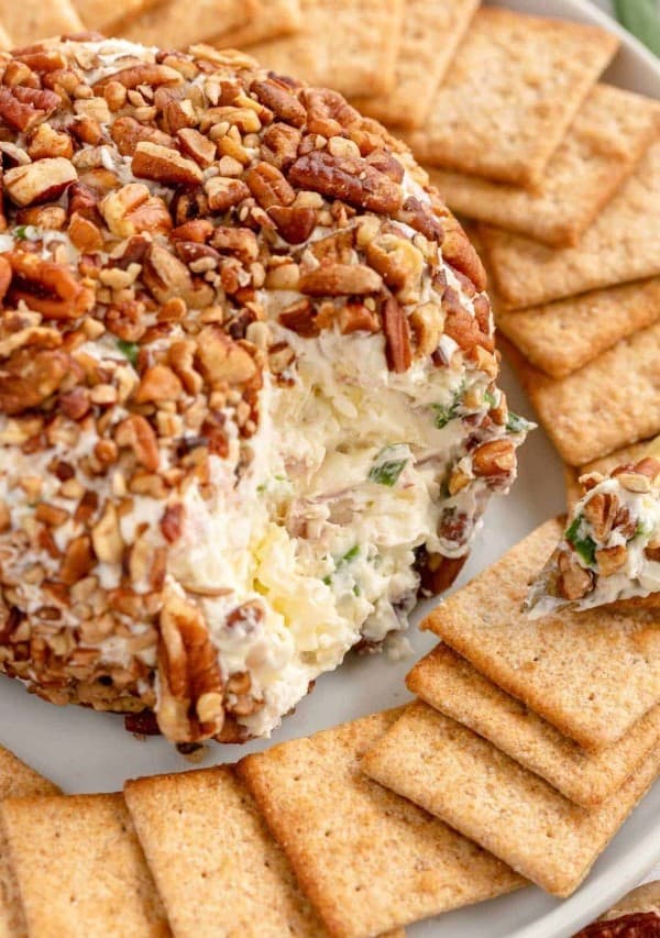 ham and pineapple cheese ball on a plate with crackers