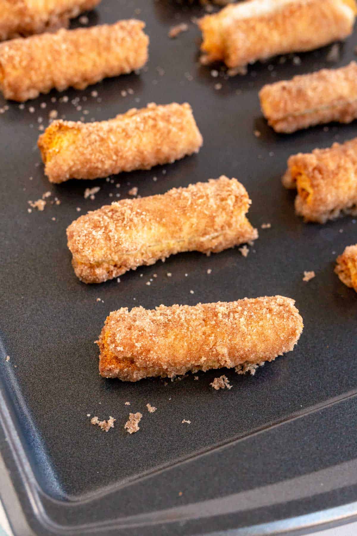 baked cinnamon cream cheese roll ups on a cookie sheet