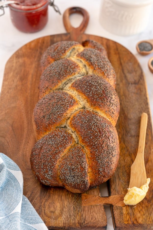 braided bread with poppy seeds on a wooden board