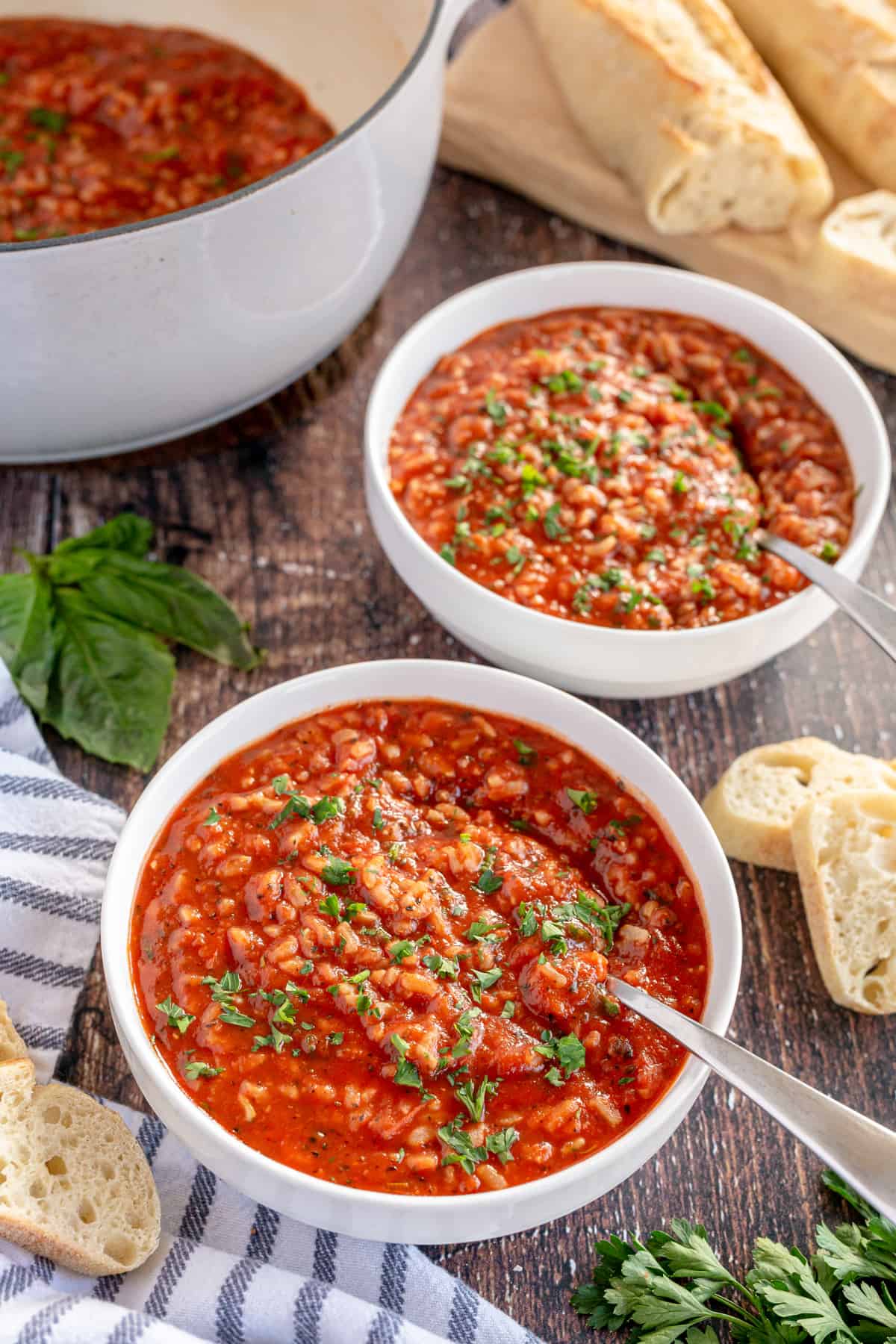 tomato rice soup in two bowls with bread
