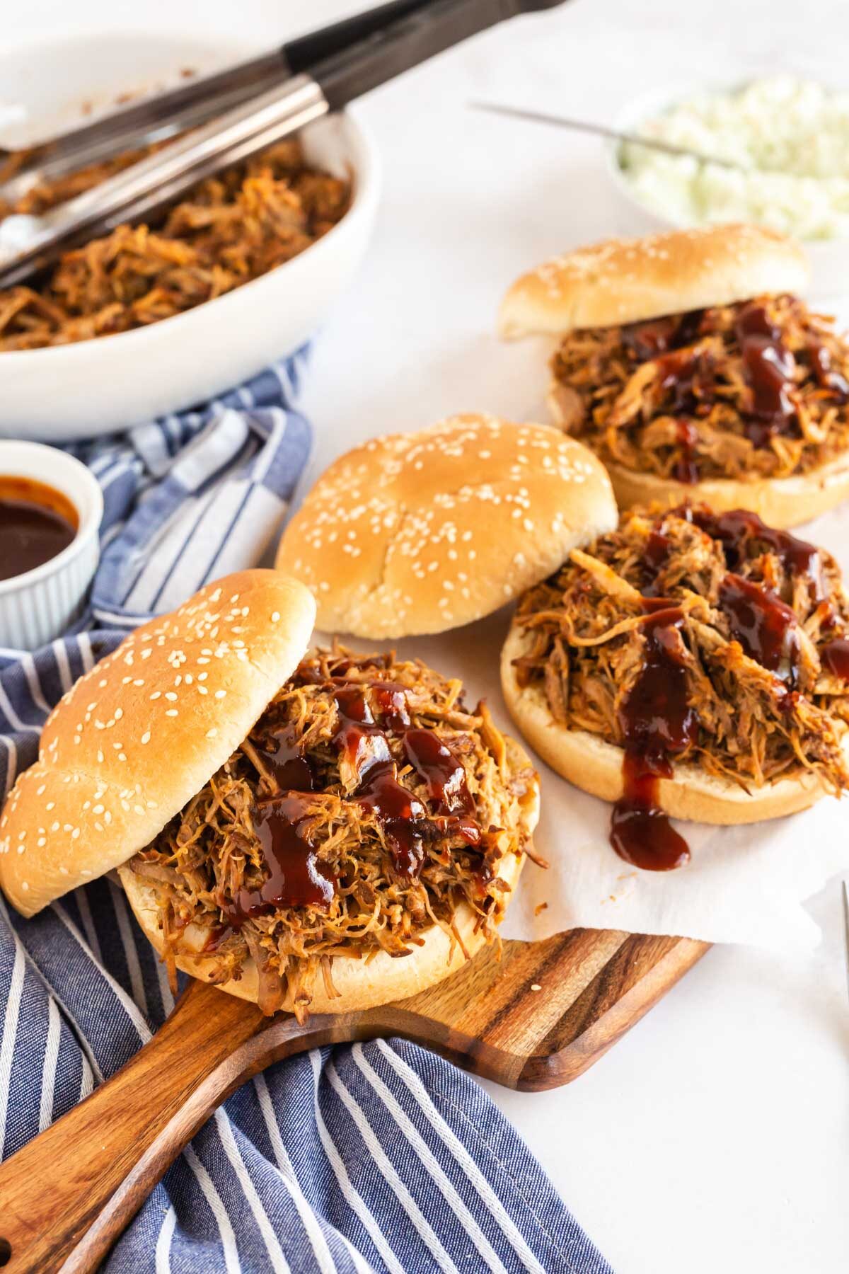 3 pulled pork sandwiches in sesame buns