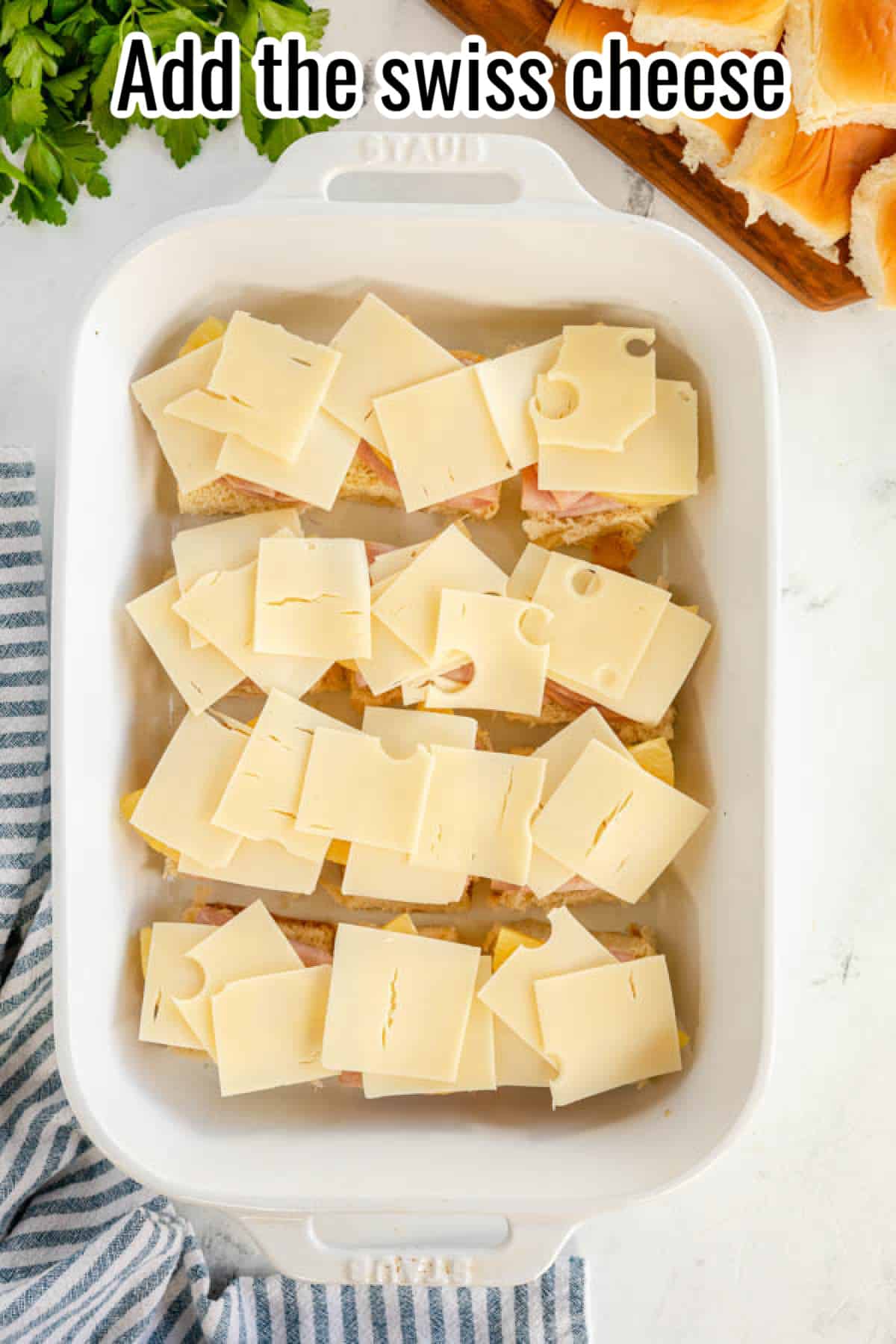 Add the swiss cheese to the ham and cheese sliders.