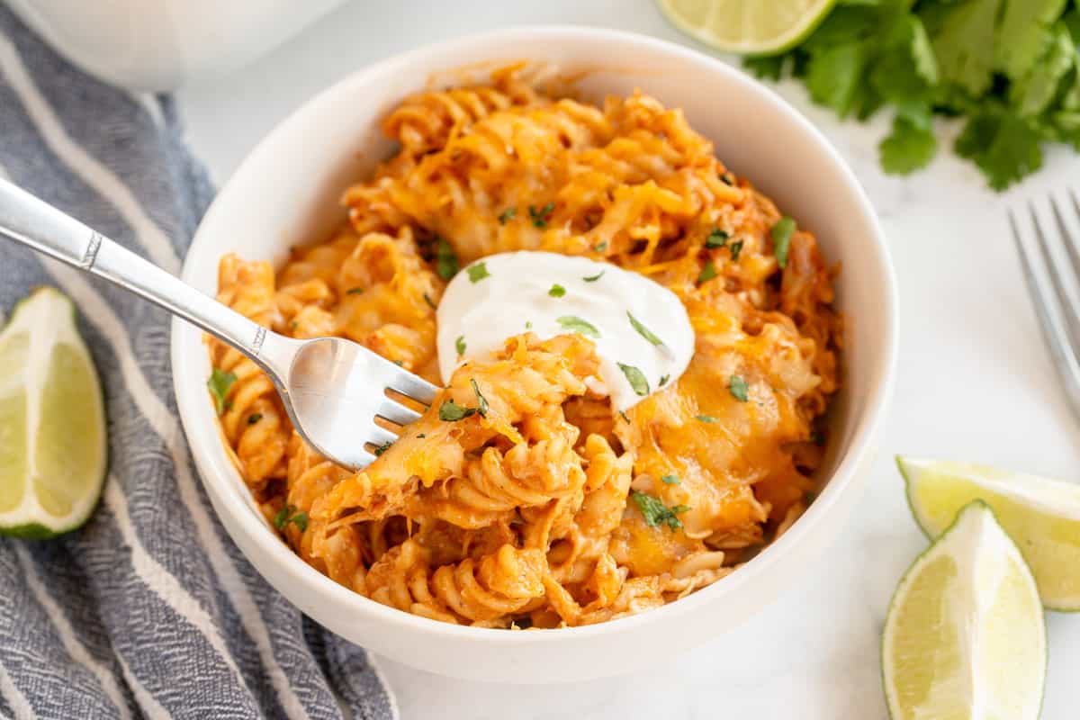 enchilada pasta in a white bowl with a fork