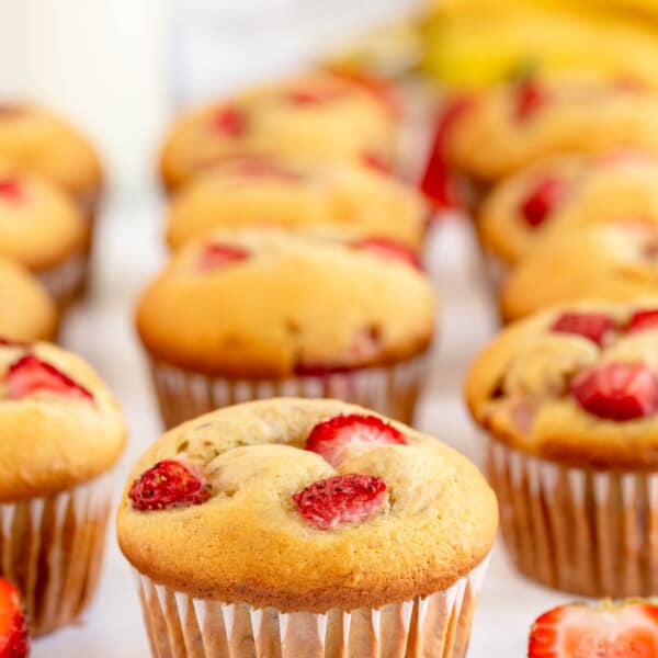 strawberry muffins with a bottle of milk in the background