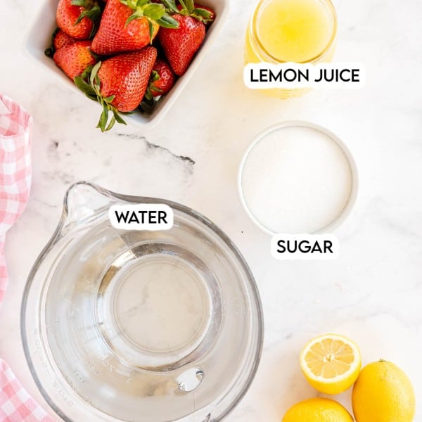 ingredients to make strawberry lemonade with an empty pitcher