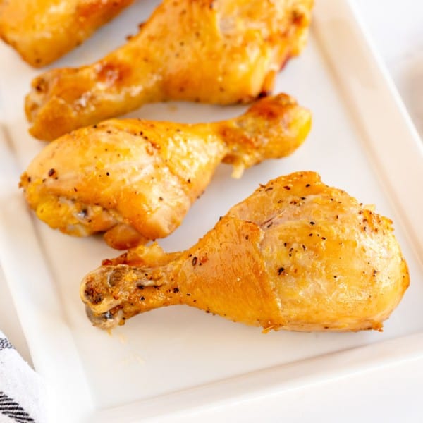 roasted chicken drumsticks on a white plate
