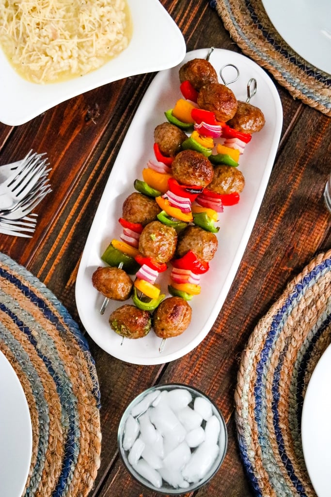 Italian meatball kabobs in white serving dish.