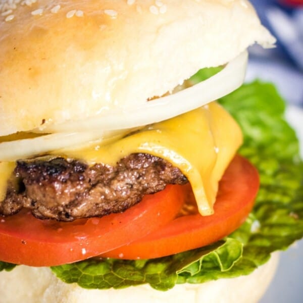 Burger with lettuce, tomato, cheese on a homemade hamburger bun