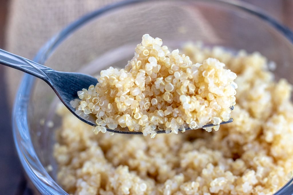 close up of a spoon full of cooked quinoa