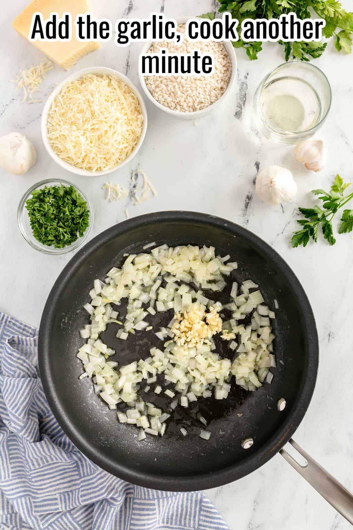 a black skillet with onion and garlic in it.