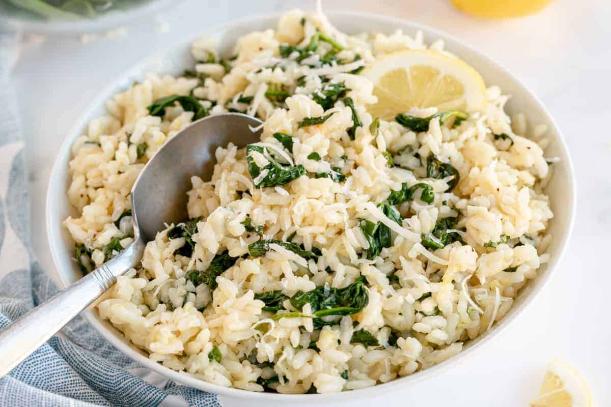 spinach risotto in a white bowl