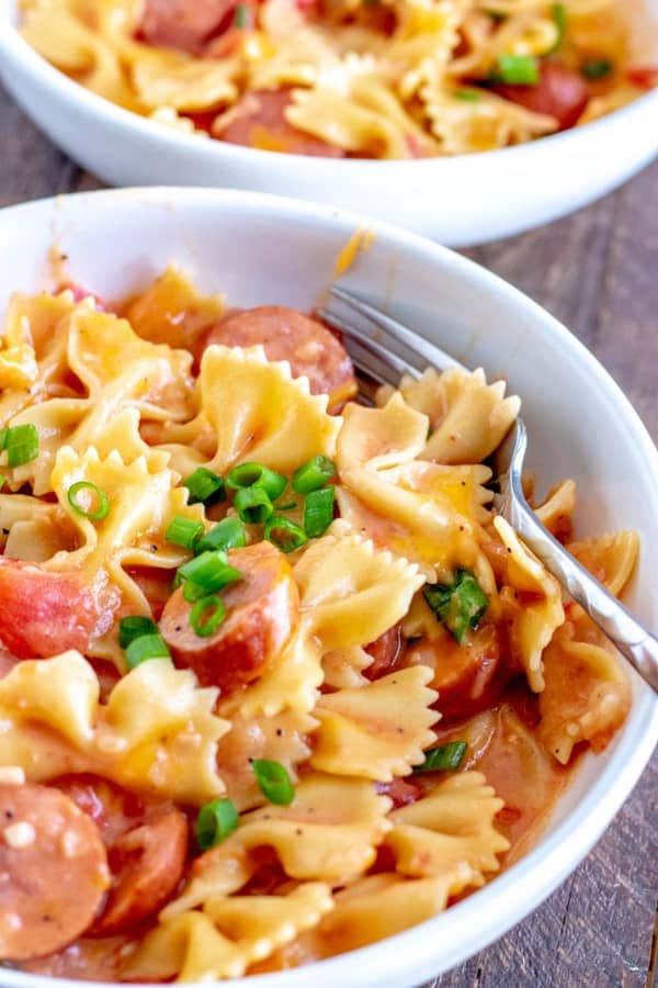 bowl of sausage pasta with a fork