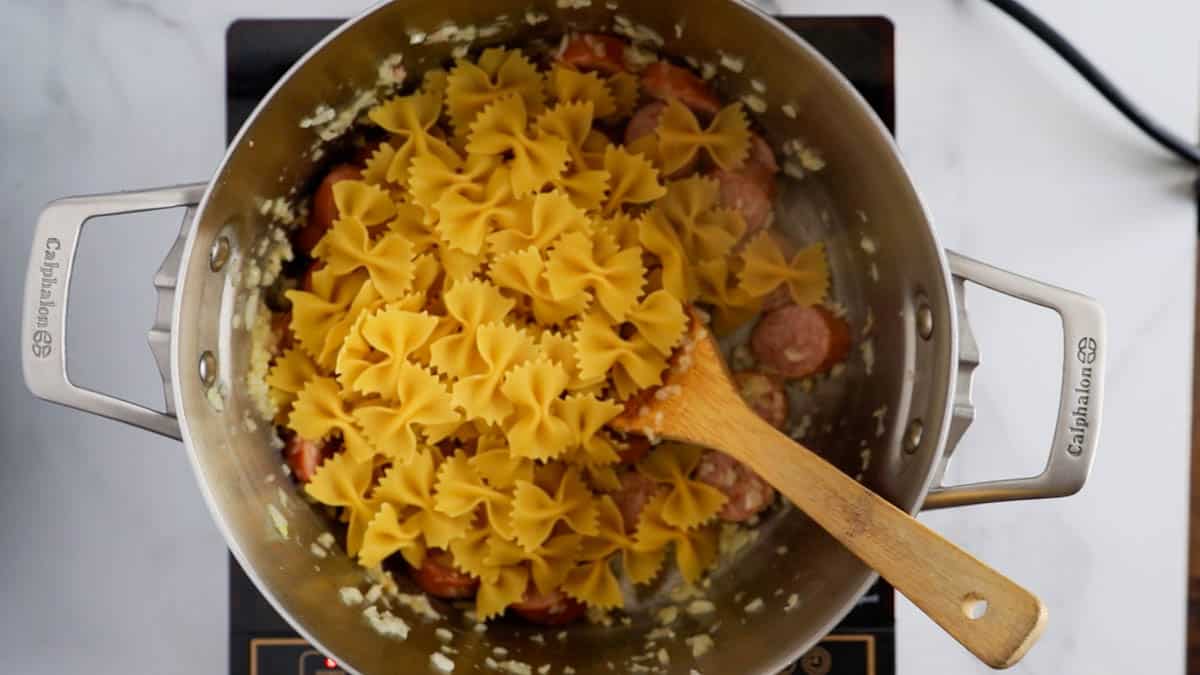 a skillet with farfalle pasta in it.