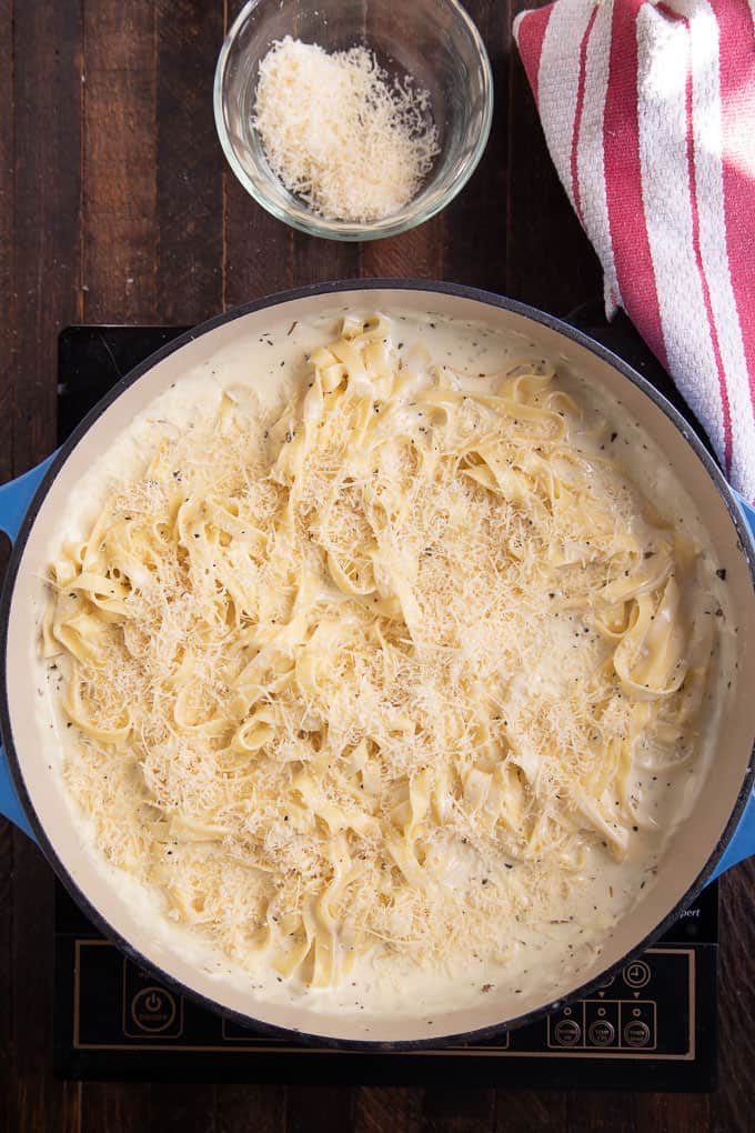 skillet with fettuccine alfredo with parmesan.