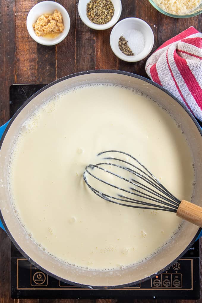 skillet with creamy sauce and whisk.