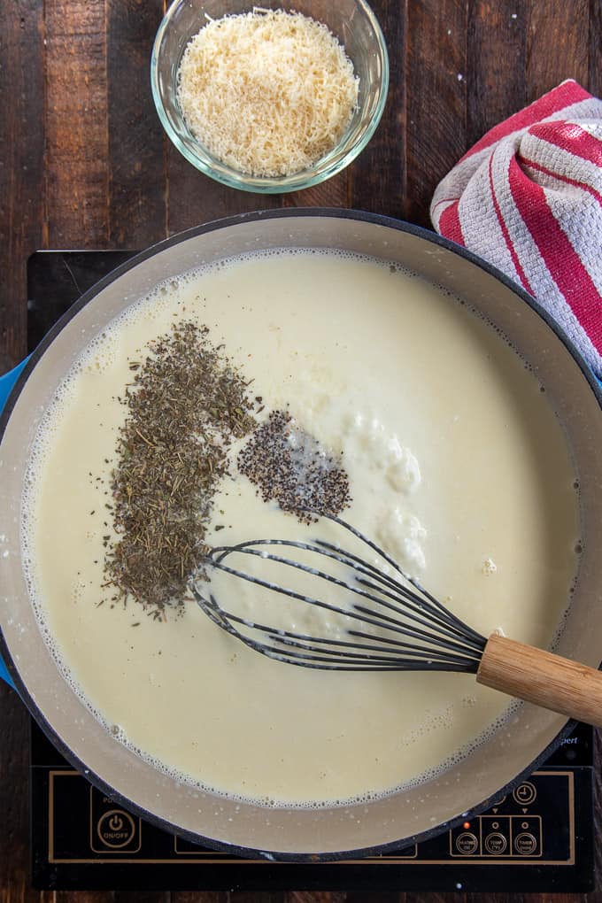 skillet with creamy sauce seasonings and whisk.