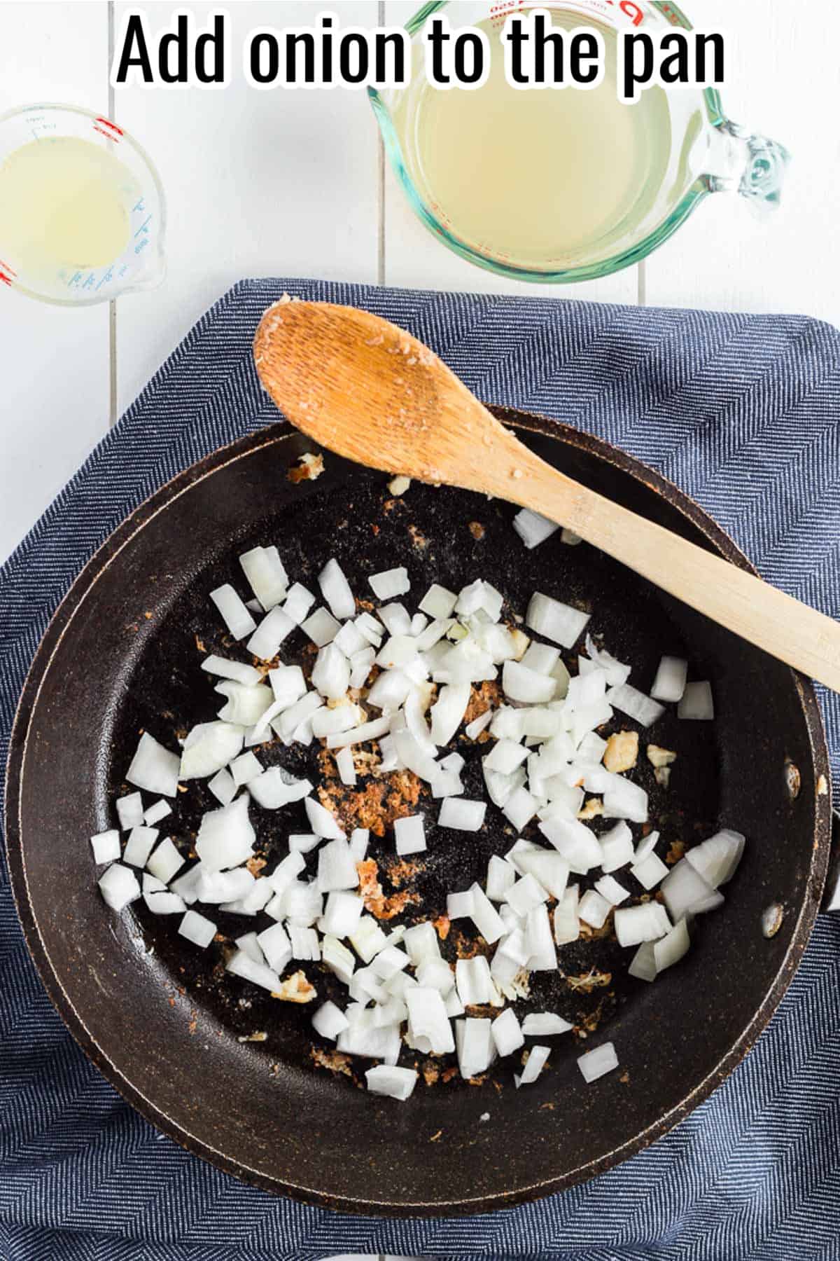 uncooked diced onion in a black skillet.