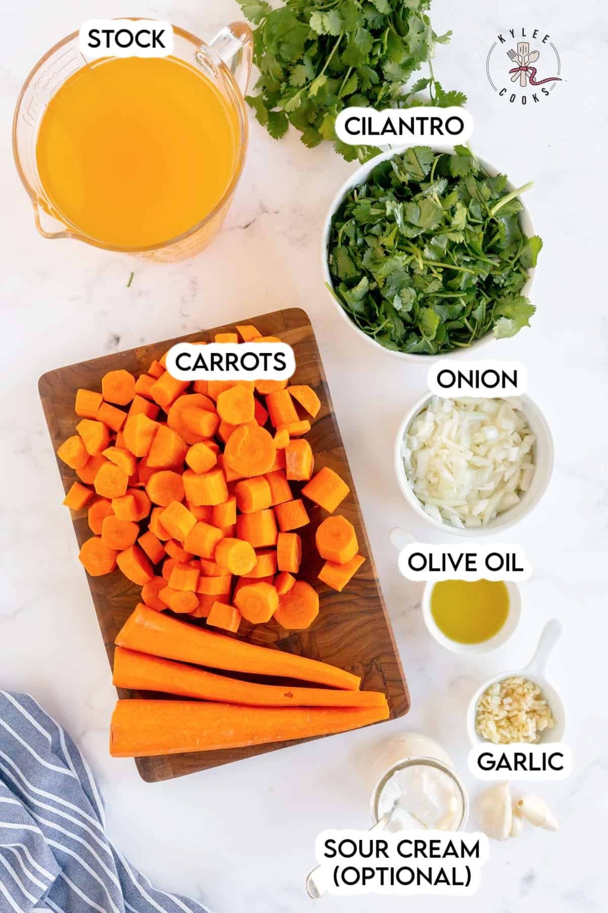 ingredients to make carrot soup laid out and labeled
