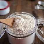 homemade bisquick in a glass jar with a wooden spoon