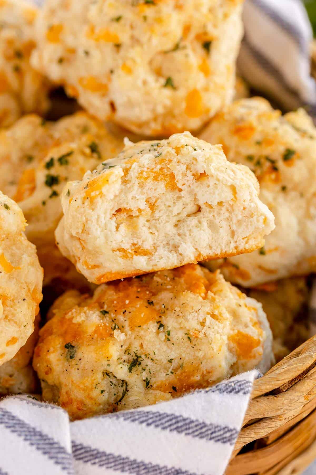 basket of fresh red lobster biscuits, with one cut open to show the inside.