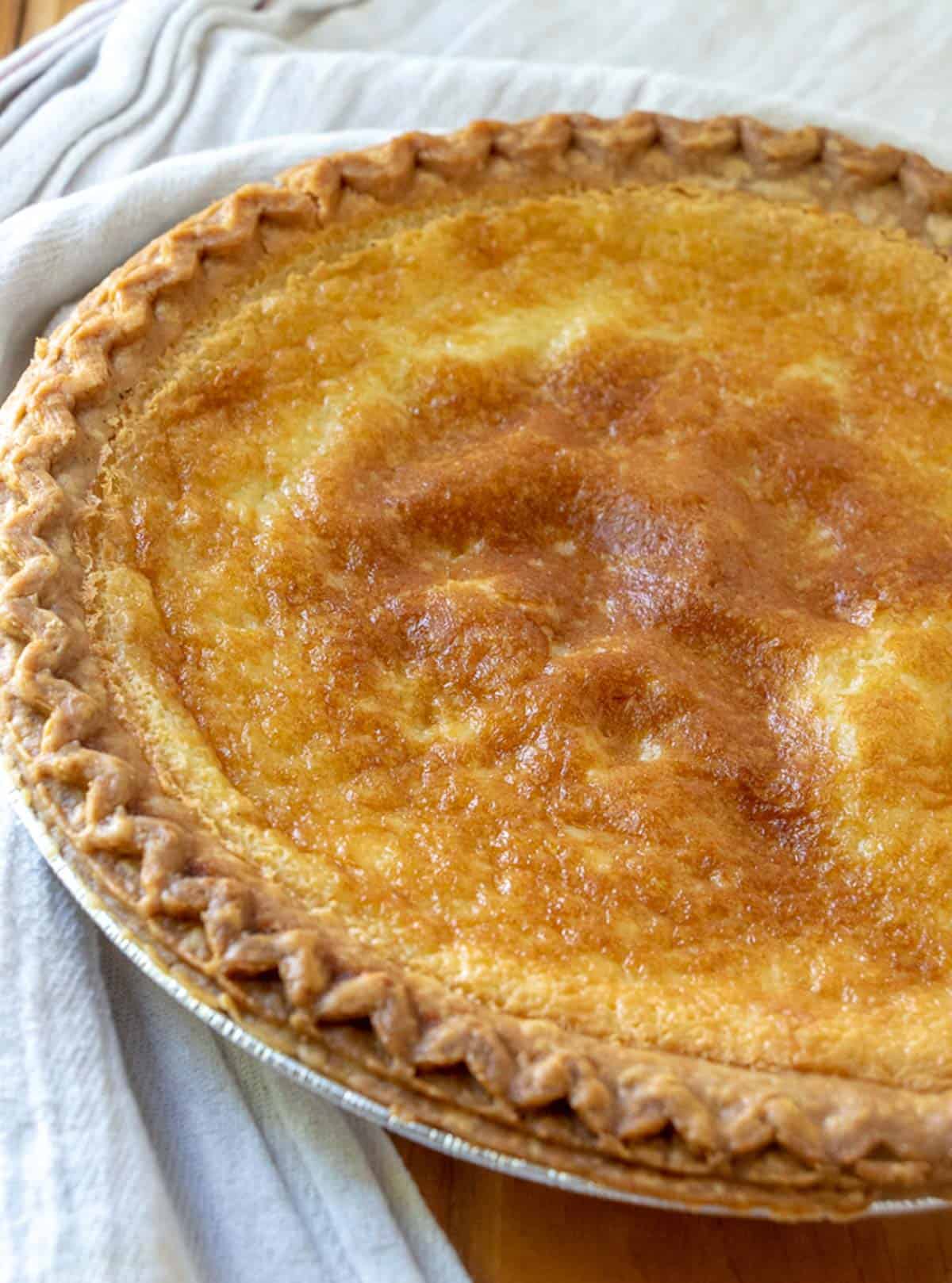 cooked buttermilk pie in a metal tin