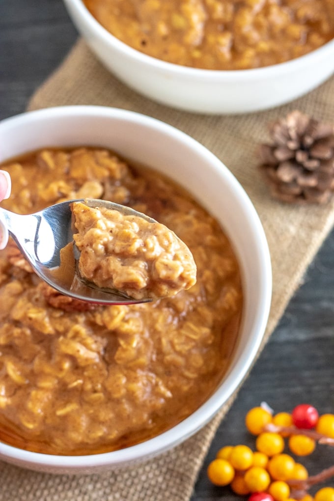 pumpkin oatmeal in a white bowl, with a spoon