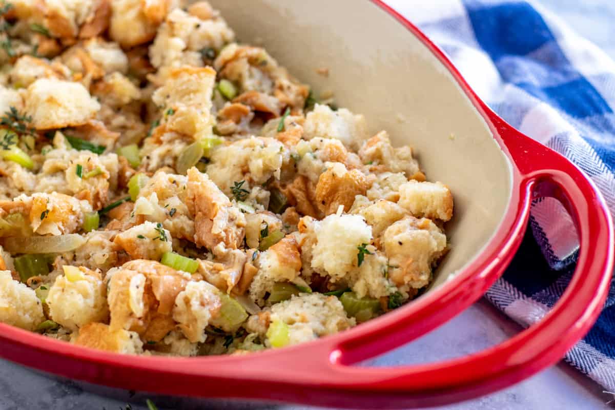 homemade stuffing in a red casserole dish 
